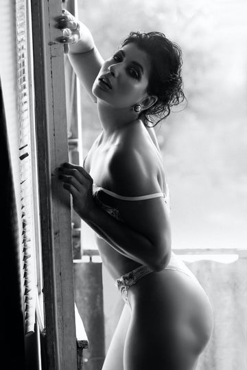 Confident woman in lingerie enjoying a relaxed, blissful moment after using a vibrator — capturing the beauty of self-discovery and first-time pleasure.